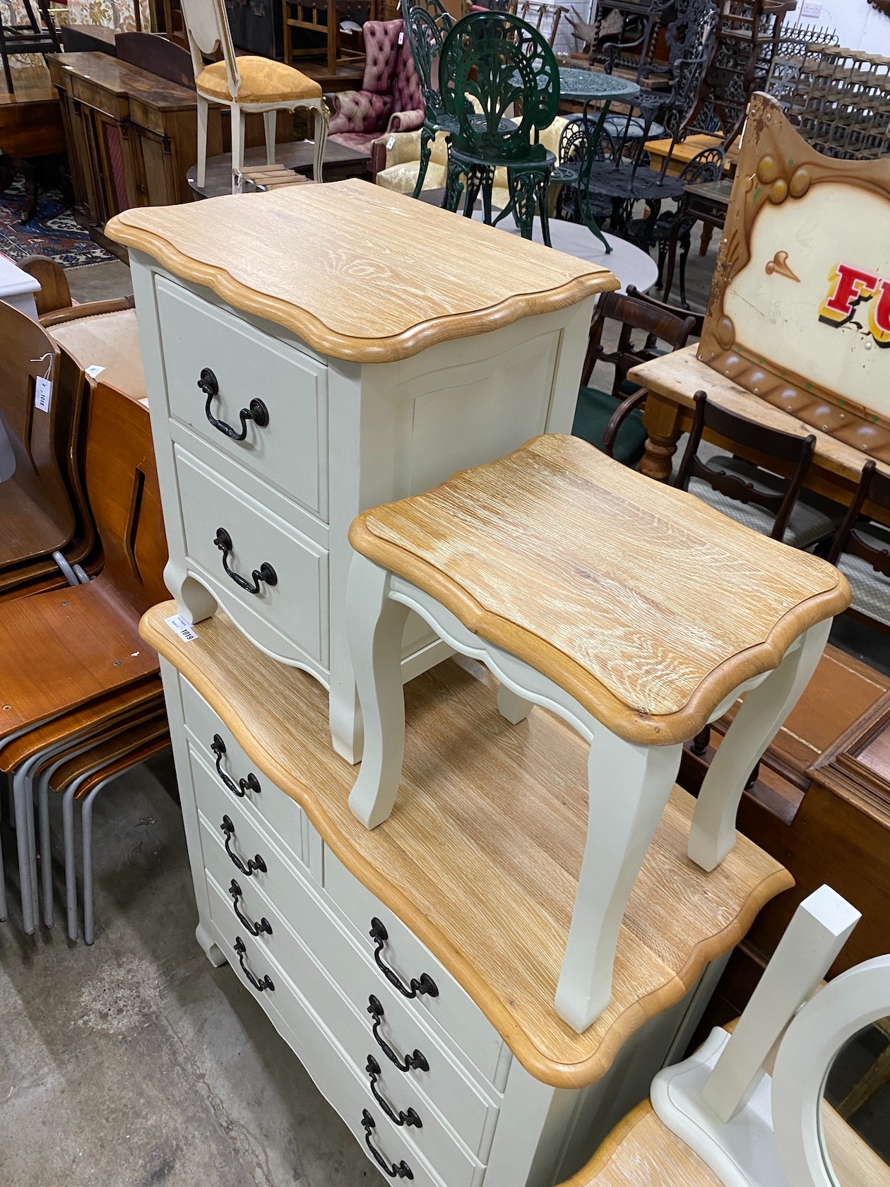 An oak and eau de nil painted wood six piecebedroom suite, from 'Oak Furniture Land' comprising a chest of drawers, dressing table and stool, a mirror and two bedside chests